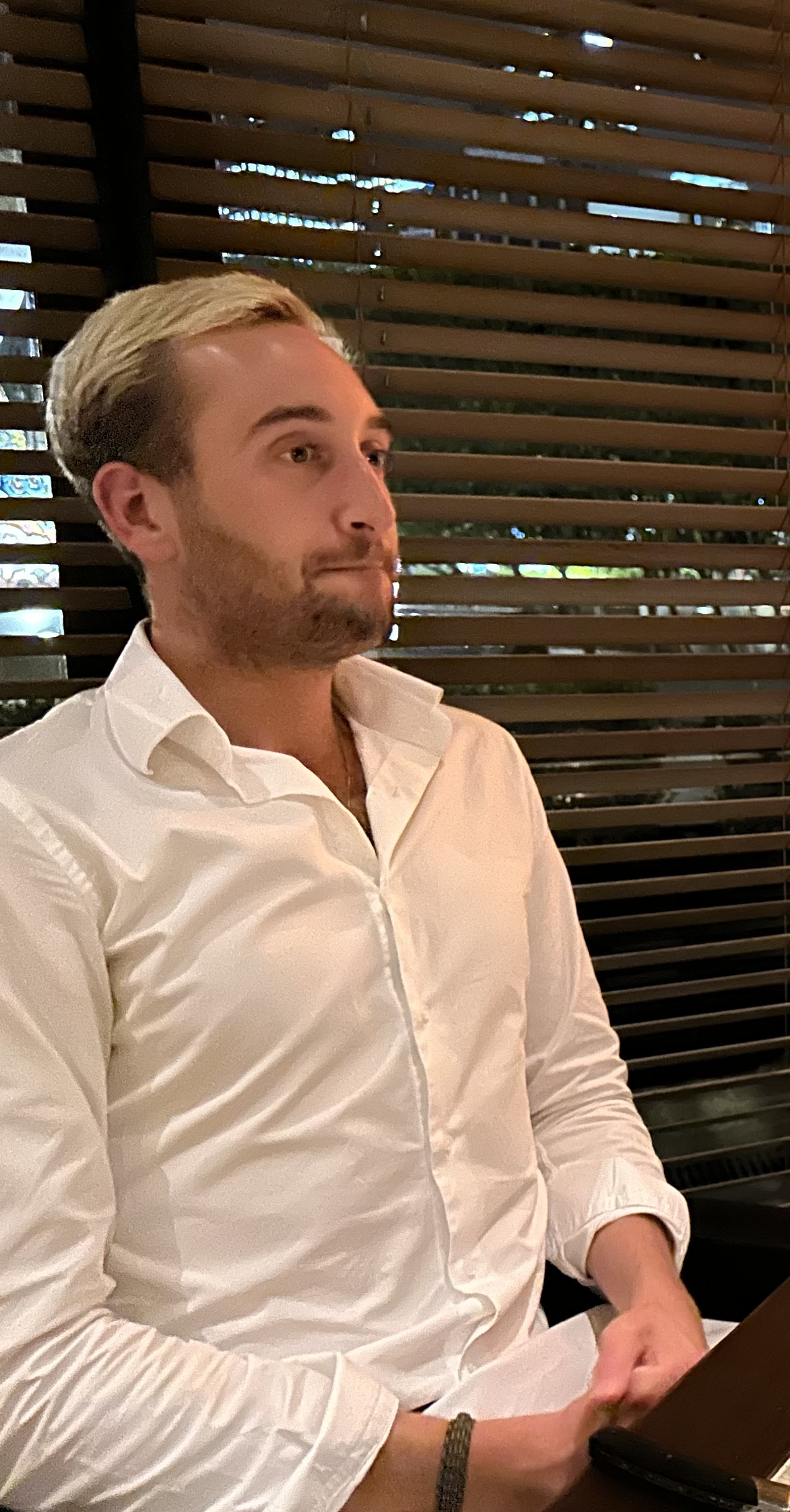 Nick contemplating his choices at a mid-century steakhouse